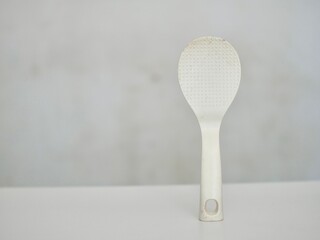 A white rice ladle with a white background in Indonesia is often called a centong nasi