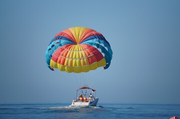 Parasailing. Parachute flight behind the boat. Vacation at the sea.