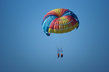 Parasailing. Parachute flight behind the boat. Vacation at the sea.