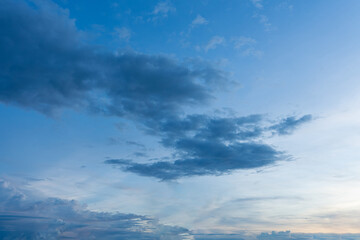 Obraz premium Fluffy blue clouds drift across a clear blue sky