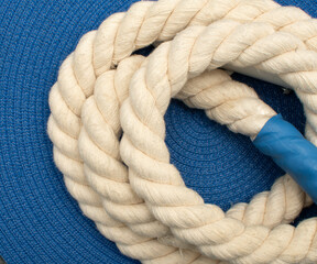 Detail of a twisted rope on blue background