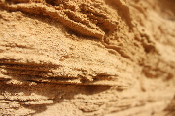 Sandstone or sand close up with ridges in the wall. Kauai Hawaii cliff hike. 