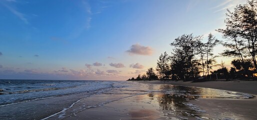 Blue skies and afternoon sunlight provide serenity on the beachfront