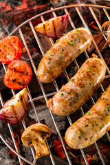 grilled sausages. spices and herbs on black background close up. Roasted homemade wurst sausages