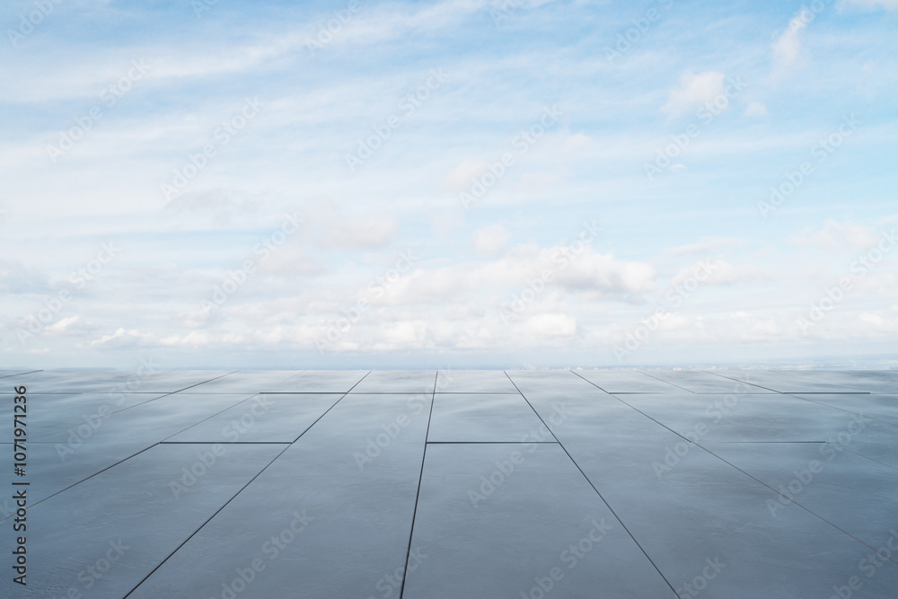 Poster Expansive rooftop view under a bright sky with soft clouds.