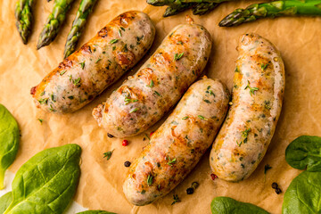 grilled sausages. spices and herbs on black background close up. Roasted homemade wurst sausages