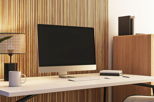 Closeup of modern desktop setup with a blank screen computer in a stylish office space with wood accents and minimal decor. 3D Rendering