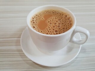 Close up of hot tea with milk or popularly known as Teh Tarik in Singapore and Malaysia