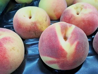 Tasty ripe peaches for sale . Retail industry