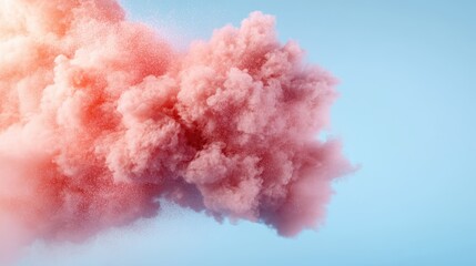 A vibrant pink cloud is set against a radiant blue backdrop, offering a beautiful contrast that emphasizes the boldness and unity of the natural elements.