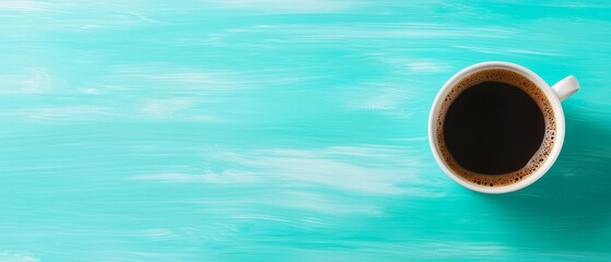 A cup of coffee sitting on top of a blue table