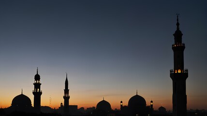 Fototapeta premium The silhouette of a mosque with a call to prayer echoing across the city at dusk.