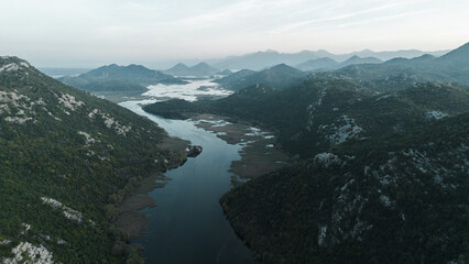 Rijeka Crnojevica river near Skadar lake in Montenegro. A winding river among the rocky mountains. Breathtaking landscape aerial view.