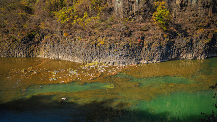 Autumn scenery of the Hantan River Columnar Joint Road, with canyons and cliffs formed by the river flowing through the volcanic terrain. (emerald water)