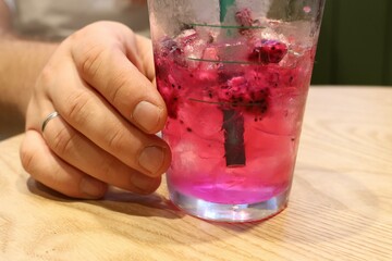 hand holding a glass of water