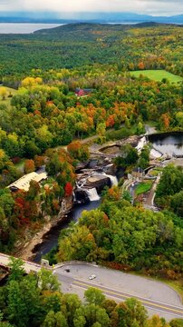 Waterfalls near hydroelectric station in Ausable Chasm canyon. A beautiful aerial view of the autumn forest and lake.
