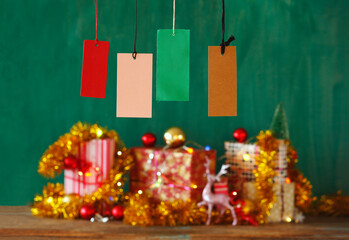 Christmas shopping and christmas present concept with blank hang tags and bluttrd gift wrapped christmas gifts.Selective focus,free copy space.