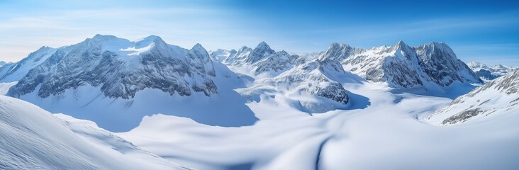 Obraz premium A snowy mountain range with a clear blue sky