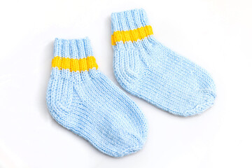 Warm, woolen knitted socks isolated on white background. Warm socks made of wool for winter season. 
