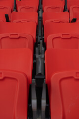 Fototapeta premium Empty red and yellow seats in the stadium stands