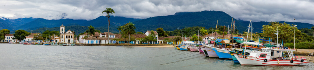 Panoramic view of Paraty Bay, historic center of Paraty and tourist boats at the pier in Rio de Janeiro, Brazil. World Heritage Site on the Brazilian Coast