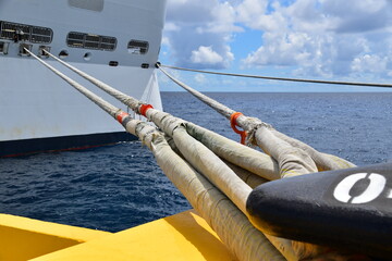 Close-up of the mooring lines connected a mooring bollard to the stern of a large cruise ship