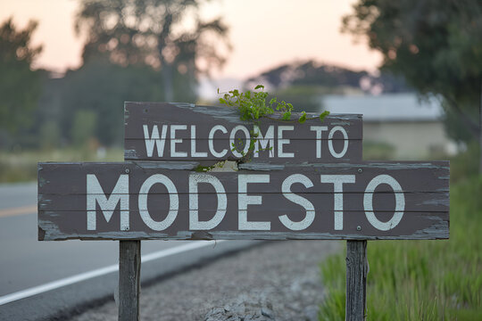 Elegant wooden "Welcome to Modesto" sign, ideal for US city entrance road signs, travel signage, urban landmarks, and city-themed promotional projects.