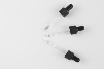 Pipettes with liquid on a white background