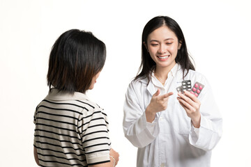 Asian female pharmacist gives advice about medicine to patient at the pharmacy department in a...