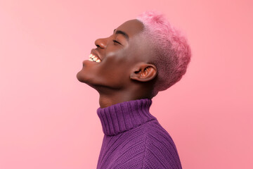 queer black man with short pink hair in  a purple sweater smiling,  side profile on pink studio background