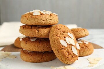 Tasty cookies with almond flakes on table, closeup