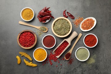 Different aromatic spices on grey table, flat lay