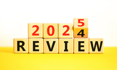 Planning 2025 review new year symbol. Concept words 2024 Review to 2025 Review on beautiful wooden blocks. Beautiful yellow table white background. Business 2025 review new year concept. Copy space.