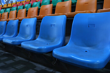 Fototapeta premium Photo of the colorful benches in a sports hall in the stands