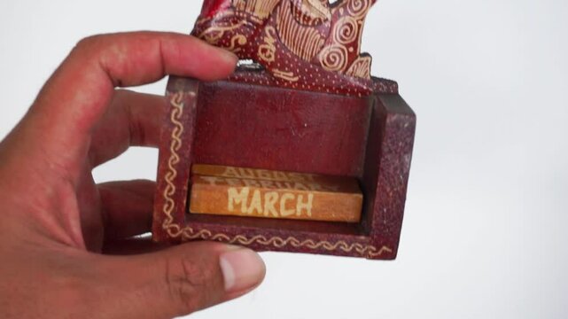 A lifetime calendar in the form of a wayang (javanese puppet) and made of wood