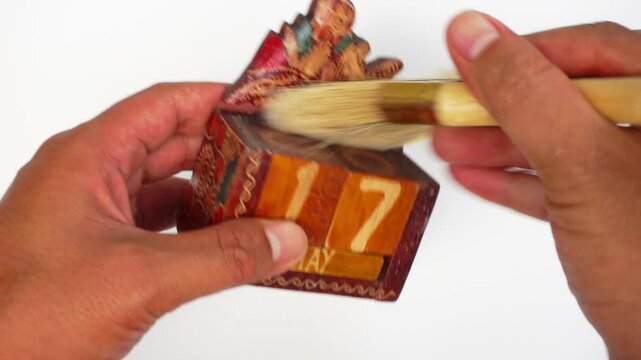 A lifetime calendar in the form of a wayang (javanese puppet) and made of wood