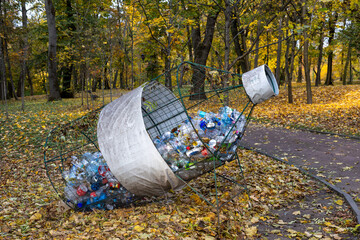 Fototapeta premium A recycling bin designated for plastic bottles highlights the importance of waste sorting and reducing plastic pollution. The scene reflects eco-friendly practices and awareness about recycling.
