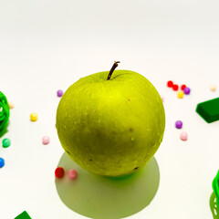 Green Apple with leaf and water droplets isolated on white background.