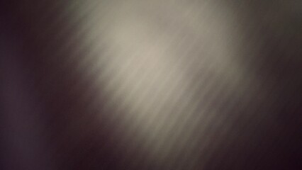Abstract, textured background with a subtle spotlight effect. The image features a gradient of dark gray to light gray, with visible texture throughout. This image was created with digital engineering