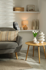 Sofa with soft cushion and coffee table in living room. Interior design