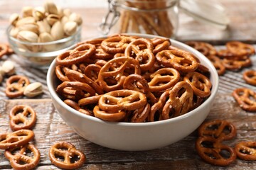 Delicious salty pretzel crackers on wooden table, closeup
