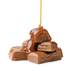 Caramel sauce dripping onto candies on white background, closeup