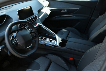 Steering wheel and dashboard inside of modern luxury car, closeup