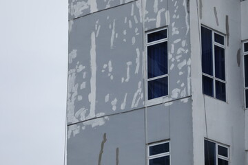 cracked outer wall of the apartment patched with cement and leak-proof paint