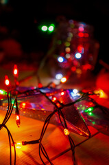 A New Year's garland with rich lights on a dark bokeh background creates a warm and mysterious atmosphere of a magical holiday