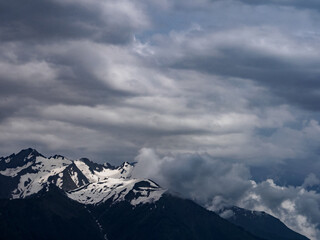 Close-up of mountain peaks adorned with snow caps, reflecting the power and beauty of the wild