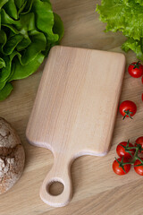 A light cutting board lies on the kitchen table, top view.