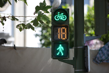 green traffic light for pedestrians and bicycles, cyclists and indicator and timer for changing from pedestrians and bicycles to cars and motor vehicles. Road safety concept.