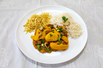 Traditional and exotic Brazilian dish rice, chicken and pequi (caryocar brasileinse) 