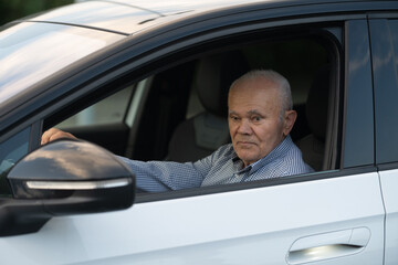 Elderly Man Sitting in Driver’s Seat of Car